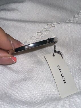 Coach Silver Tone Slim Hinged Bangle with Crystal Accents